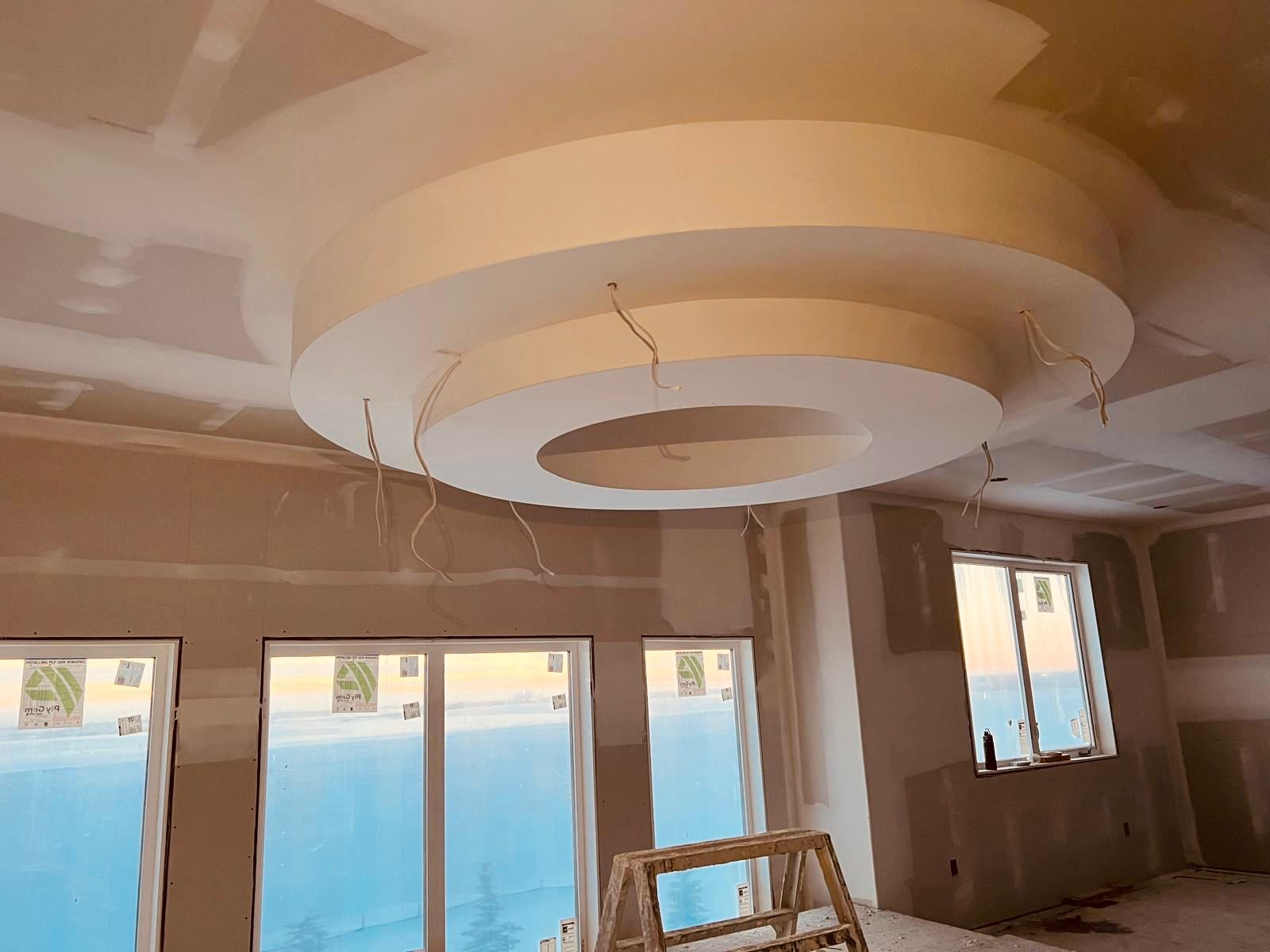 Circular tiered drywall ceiling feature on a Calgary build