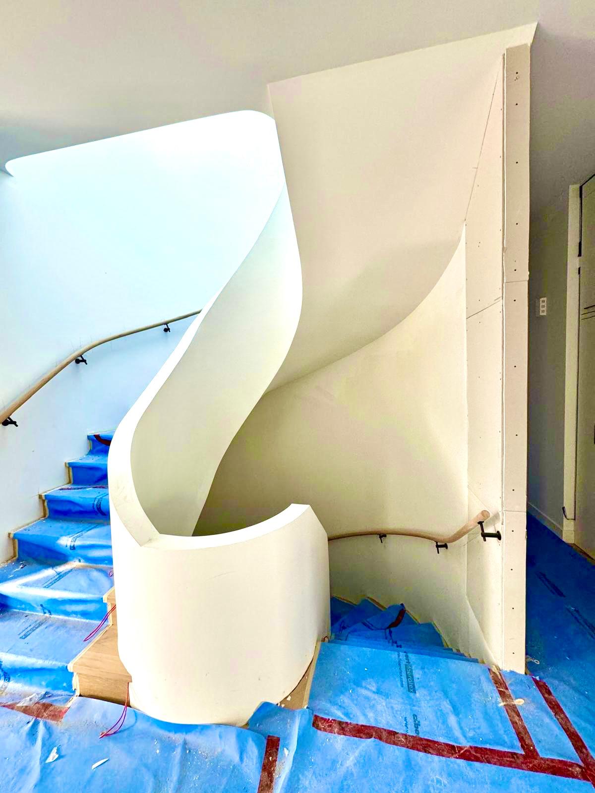 Curved drywall stairwell wall finished smooth